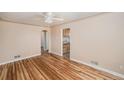 Inviting living room with hardwood floors, a ceiling fan, and an archway at 1200 Newark St, Aurora, CO 80010