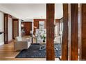 Stylish living room with wood columns, fireplace, and dark blue rug on hardwood floors at 2800 E 2Nd Ave # 202, Denver, CO 80206