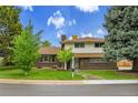 Charming two-story home featuring brick and siding exterior with a well-manicured lawn at 7076 S Spruce W Dr, Centennial, CO 80112