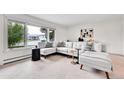 Bright living room with large window and neutral decor at 7076 S Spruce W Dr, Centennial, CO 80112