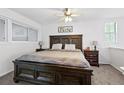Cozy bedroom with a large wooden bed frame, side tables, and a neutral color palette at 13228 E Asbury Dr, Aurora, CO 80014