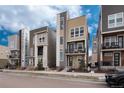 Modern townhouses with neutral exteriors and balconies, offering urban living at 2615 Mayotte Way, Castle Rock, CO 80109