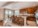 Open kitchen with granite countertops, a breakfast bar, and adjacent dining area overlooking mountain views at 10480 Skyreach Rd, Highlands Ranch, CO 80126