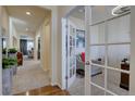 Bright hallway with hardwood and carpet flooring leading to a living area and study with french doors at 3164 S Kirk Way, Aurora, CO 80013