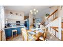 Bright dining area adjacent to the kitchen, featuring a stylish chandelier and staircase access at 17588 E Dickenson Pl, Aurora, CO 80013