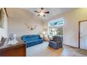 Comfortable living room with large window, natural light and neutral color palette at 17588 E Dickenson Pl, Aurora, CO 80013