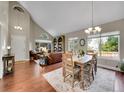 Open-concept living room with vaulted ceilings, hardwood floors, and abundant natural light at 1052 Northampton Ct, Highlands Ranch, CO 80126