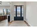Welcoming foyer features a decorative glass front door and hardwood floors at 428 Pontiac St, Denver, CO 80220