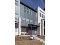 Charming townhome with a covered front porch and a combination of siding and brick, presenting a modern look at 10177 E 62Nd Ave, Denver, CO 80238