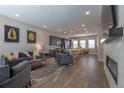 Open-concept living room features stylish decor, hardwood floors, and seamless flow to the kitchen and dining area at 10177 E 62Nd Ave, Denver, CO 80238