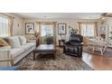 Comfortable living room with plush rug, neutral tones, and natural lighting at 9942 Lane St, Thornton, CO 80260