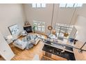 A bright living room is displayed from an aerial view, including a fireplace, kitchen, and walk-out balcony at 5677 S Park Pl # D310, Greenwood Village, CO 80111