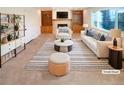 Bright, carpeted living room with built-in shelving, fireplace, and large window at 1703 S Moline Ct, Aurora, CO 80012
