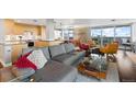 Open-concept living space with modern furnishings, city views, and hardwood floors at 4570 E Yale Ave # 1104, Denver, CO 80222