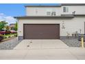 Attached two-car garage featuring a paved driveway and modern exterior finishes on the home at 4760 Kittredge St, Denver, CO 80239