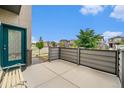 Private patio with wood-look fence offering a cozy outdoor living space next to the front door at 4760 Kittredge St, Denver, CO 80239