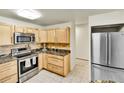 Kitchen with stainless steel appliances, tile backsplash, and ample cabinet space at 710 S Alton Way # 5A, Denver, CO 80247