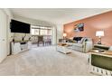Bright living room featuring neutral carpet, sliding glass doors, and stylish décor at 710 S Alton Way # 5A, Denver, CO 80247