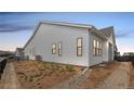 Side view of a single-Gathering home featuring horizontal siding and black trim windows at 11442 Autumn Moon St, Littleton, CO 80125