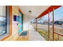 Inviting front porch features a colorful door, updated wood siding, and a charming entrance at 1345 S Meade St, Denver, CO 80219