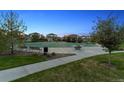 Community basketball court surrounded by mature trees and lush landscaping at 12264 Olive Way, Thornton, CO 80602