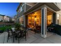 Covered patio with outdoor seating, dining, and grill perfect for entertaining guests at 12264 Olive Way, Thornton, CO 80602