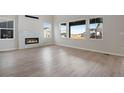 Spacious living room featuring modern fireplace with decorative tile surround and large windows at 24661 E 33Rd Dr, Aurora, CO 80019