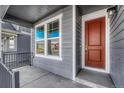 Inviting covered porch with a stained wood front door, white trim, and iron railing at 246 Mohawk Cir, Superior, CO 80027