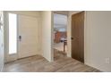 Entryway features sleek tile flooring, a glass-paneled front door, and views of the living area at 2707 S Richfield St, Aurora, CO 80013