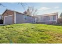 A single-story home featuring well-maintained siding, an attached garage and a well-manicured lawn at 2707 S Richfield St, Aurora, CO 80013