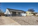 Charming single-story home featuring a covered porch, rockscape yard, and sunny exterior at 433 S Xavier St, Denver, CO 80219