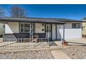 Inviting front porch with seating, decorative railings, and a cozy, welcoming entrance at 433 S Xavier St, Denver, CO 80219