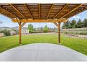 Lush backyard with a pergola, a wooden shed, and a well-manicured lawn at 6147 Dunraven St, Golden, CO 80403