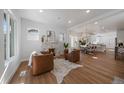 Bright living room with fireplace and open layout to dining area and kitchen at 3315 N Josephine St, Denver, CO 80205