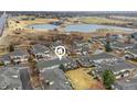 Aerial view showcases a community with townhomes near a serene lake and green spaces at 3000 E 112Th Ave # 102, Northglenn, CO 80233