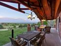 Relaxing outdoor patio with a fireplace, comfortable seating, and scenic views at 8387 N Sunburst Trl, Parker, CO 80134