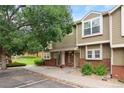 Townhouse exterior showcasing a landscaped yard and community green space, perfect for outdoor enjoyment at 9138 Gale Blvd # 2, Thornton, CO 80260