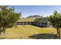 Picturesque horse stable with a mountain backdrop, surrounded by green pastures at 6145 S Perry Park Rd, Sedalia, CO 80135