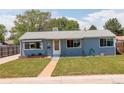 Attractive blue single-story home with well-manicured lawn at 7291 Bryant St, Westminster, CO 80030