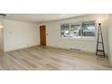Bright living room with newly installed laminate flooring at 7291 Bryant St, Westminster, CO 80030
