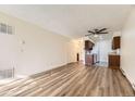 Living room showcasing wood-look flooring and adjoining kitchen area at 14720 E Kentucky Dr # 625, Aurora, CO 80012