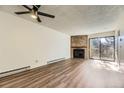 Open living room with fireplace and sliding doors to a balcony at 14720 E Kentucky Dr # 625, Aurora, CO 80012
