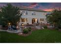 Backyard featuring patio, fire pit, lush lawn, and mature trees, perfect for outdoor living and entertaining at 6095 S Oswego St, Greenwood Village, CO 80111