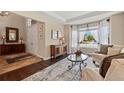 Inviting living room with hardwood floors, large bay window, and stylish decor at 6095 S Oswego St, Greenwood Village, CO 80111