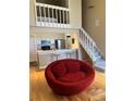 Bright living space featuring an open kitchen, staircase, and a unique red lounge chair at 4899 S Dudley St # K18, Littleton, CO 80123