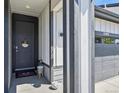 Inviting entrance with a dark-colored door, decorative wreath, and a view of the attached two-car garage at 27893 E 6Th Pl, Aurora, CO 80018