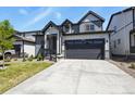 Contemporary two-story home with a gray and white exterior, a well-kept lawn, and a convenient two-car garage at 27893 E 6Th Pl, Aurora, CO 80018