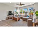Bright living room featuring large windows, comfortable sectional sofa, and stylish decor at 27893 E 6Th Pl, Aurora, CO 80018