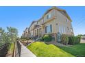 Well-maintained townhome complex with manicured landscaping and a sidewalk, showcasing a desirable neighborhood at 1732 Aspen Meadows Cir, Federal Heights, CO 80260