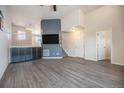 Spacious living room with modern gray floors, a stylish accent wall, and ample natural light at 1732 Aspen Meadows Cir, Federal Heights, CO 80260
